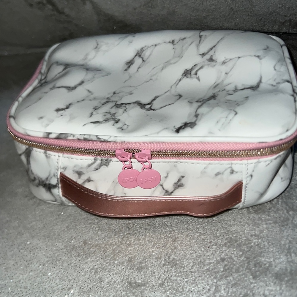 Carrera marble print makeup bag with pink and rose gold trim.